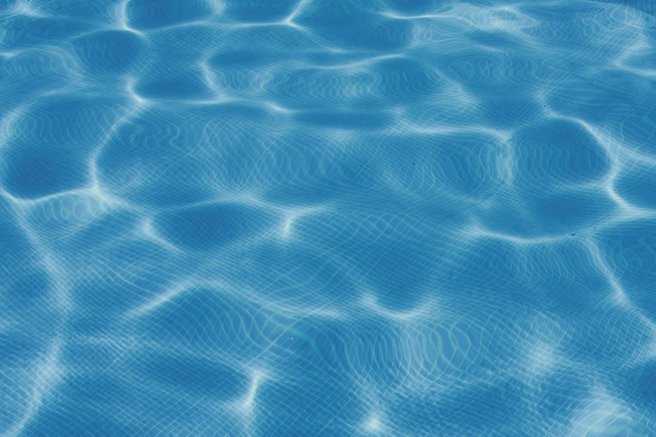 Sunlit swimming pool water